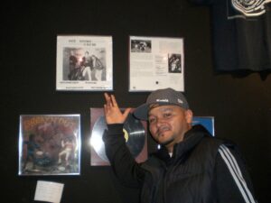 Chris "DJ Jel" Jackson at T-Dot Pioneers Hip-Hop Exhibit with Get Loose Crew record prominently displayed